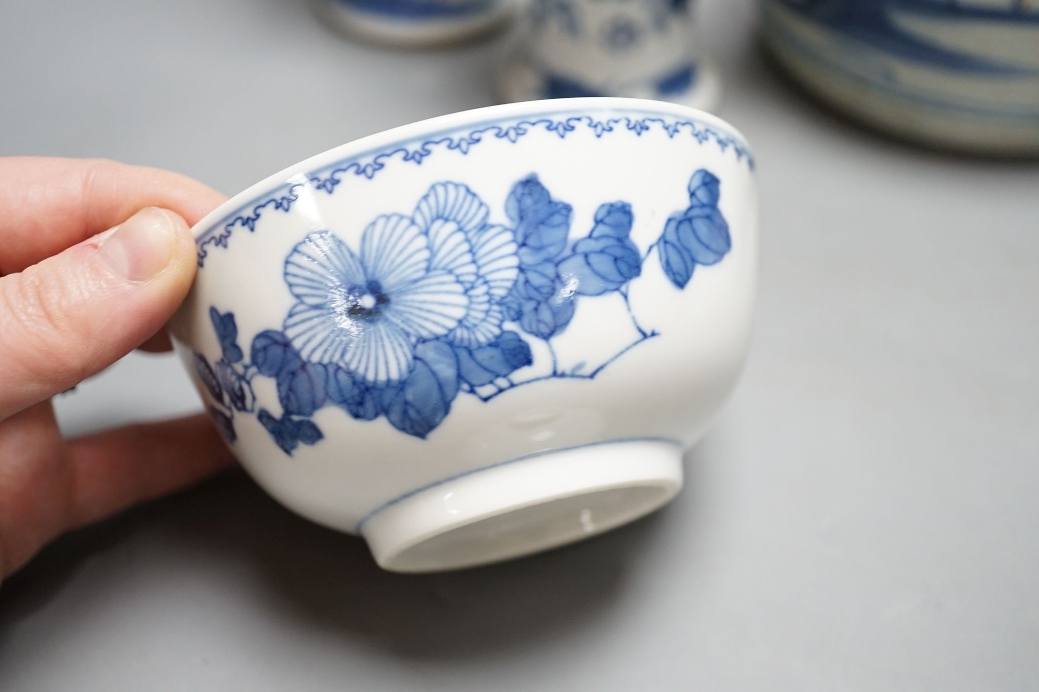 Twelve pieces of 19th century Chinese blue and white tableware and a small famille rose bowl, largest 20cm